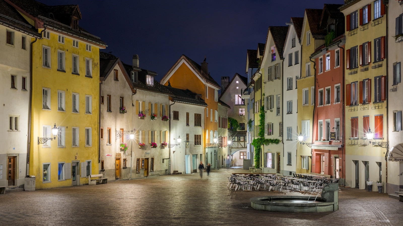 two person walking on street with lights anf greting in swiss german
