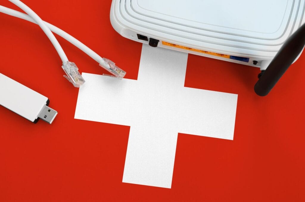 Online Shop erstellen Schweiz – WLAN Router und Netzwerkkabel auf Schweizer Flagge, Symbol für E-Commerce Infrastruktur